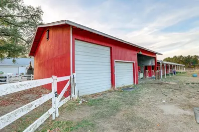 a red barn with white doors and a fence at 12 Mi to Folsom Historic District NorCal Getaway in Fair Oaks