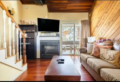 a living room with a couch and a fireplace at Cozy Condo in Mammoth with 2 parking spots! Ski,Snowboard, Ice skate! in Mammoth Lakes