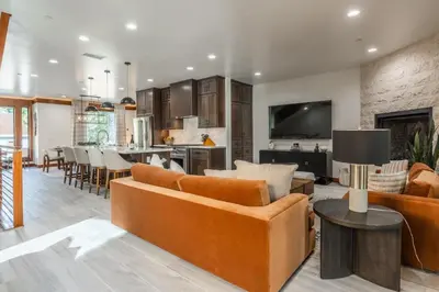 an open living room and kitchen with orange furniture at Obsidian 170 in Mammoth Lakes