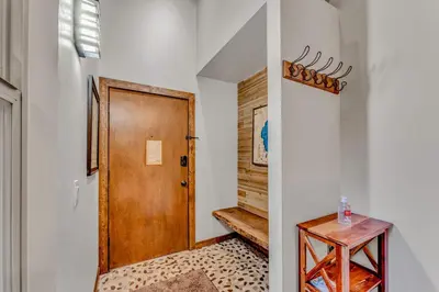 a hallway with a wooden door and a wooden table at Tahoe Condo Near Skylandia Beach in Tahoe City