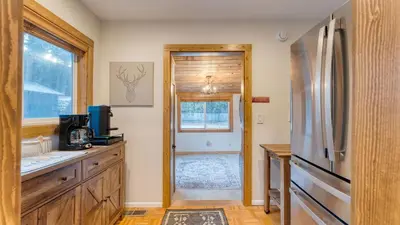 a kitchen with a refrigerator and a window at Westlake Cabin by AvantStay Hot Tub Near Skiing Walk to Restaurants Lake in Tahoe City
