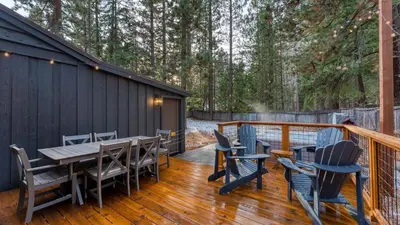 a deck with a wooden table and chairs at Westlake Cabin by AvantStay Hot Tub Near Skiing Walk to Restaurants Lake in Tahoe City