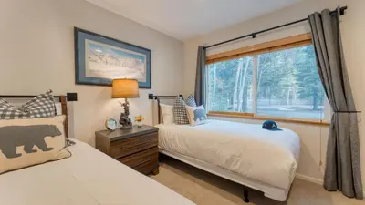 a bedroom with two beds and a window at Westlake Cabin by AvantStay Hot Tub Near Skiing Walk to Restaurants Lake in Tahoe City