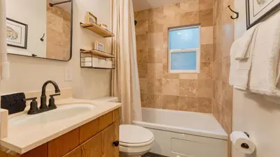 a bathroom with a sink and a toilet and a tub at Westlake Cabin by AvantStay Hot Tub Near Skiing Walk to Restaurants Lake in Tahoe City