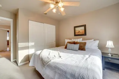 a bedroom with a white bed and a ceiling fan at Ski Getaway with Hot Tub Reno Home By Attractions in Reno