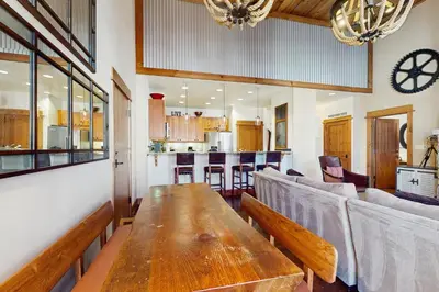 a dining room and kitchen with a wooden table at Northstar Getaway in Truckee