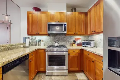 a kitchen with wooden cabinets and a stove top oven at Northstar Getaway in Truckee