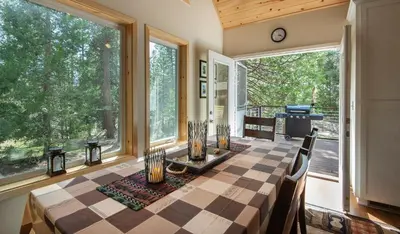 a dining room with a table and some windows at 11N Margaret in North Wawona