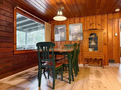 a dining room with a table and chairs at 10 Little Cabin In The Woods in North Wawona