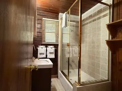 a bathroom with a shower and a sink at 10 Little Cabin In The Woods in North Wawona