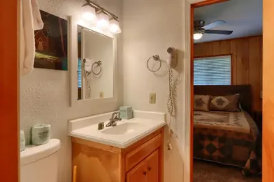 a bathroom with a sink and a toilet and a mirror at 17C The Redwoods Cabin in North Wawona