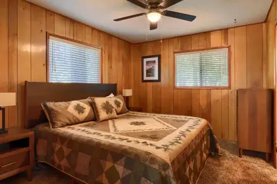 a bedroom with a bed and a ceiling fan at 17C The Redwoods Cabin in North Wawona