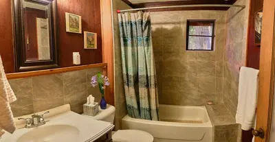 a bathroom with a sink and a toilet and a shower at 1B Heart of the Meadow at The Redwoods In Yosemite in North Wawona