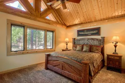 a bedroom with a bed with a wooden ceiling at Yosemite's Luxury Estate in North Wawona
