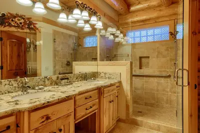 a bathroom with a double sink and a shower at Yosemite's Luxury Estate in North Wawona