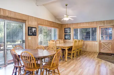 a dining room with a wooden table and chairs at Riverfront Retreat in North Wawona