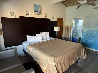 a bedroom with a large bed in a room at Cinderella Motel in Hollister