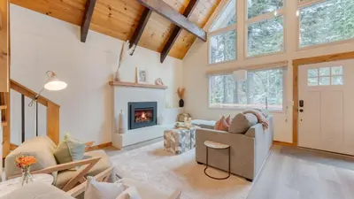 a living room with a couch and a fireplace at Peaceful Tahoe Retreat by AvantStay Cozy Modern Cabin • Sauna Hot Tub Fireplace • Near Lake in Carnelian Bay