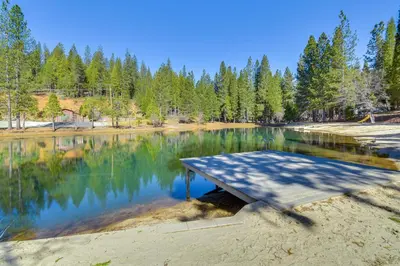a picnic table in the middle of a lake at Fire Pit, Gazebo and Grill Family Cabin in Arnold! in Arnold