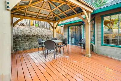 a wooden deck with a table and chairs on a house at Fire Pit, Gazebo and Grill Family Cabin in Arnold! in Arnold