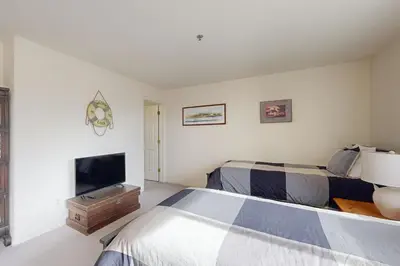 a bedroom with two beds and a flat screen tv at Bear-foot Retreat in Incline Village