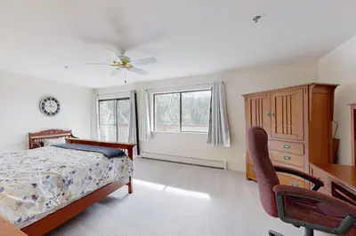a bedroom with a bed and a desk and window at Bear-foot Retreat in Incline Village
