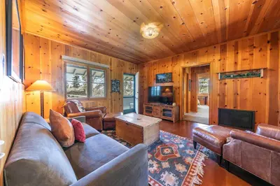 a living room with a couch and a tv at Sky Rocks - Private Beach, Buoy & Pier, HOA Swimming Pool & Tennis in Kings Beach