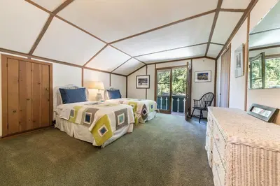 two beds in a room with a window at Sky Rocks - Private Beach, Buoy & Pier, HOA Swimming Pool & Tennis in Kings Beach