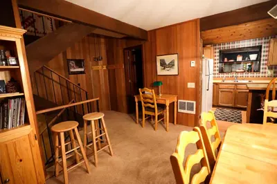a room with a kitchen and a table and chairs at Updated Mammoth condo on Red line in Mammoth Lakes