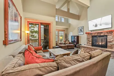 a living room with a couch and a fireplace at Grandeur at Elevation – 3 Bedroom Loft condo in Kirkwood