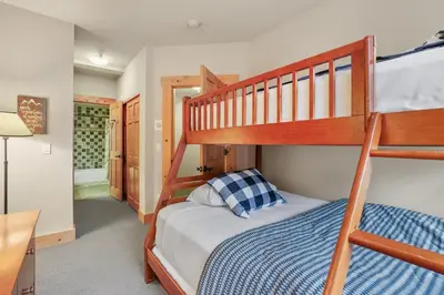 a bedroom with two bunk beds and a bathroom at Grandeur at Elevation – 3 Bedroom Loft condo in Kirkwood