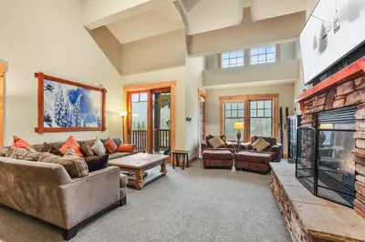 a living room with couches and a fireplace at Grandeur at Elevation – 3 Bedroom Loft condo in Kirkwood