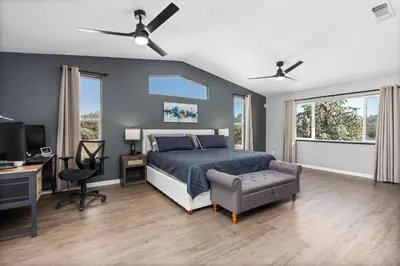 a bedroom with a bed and a desk with a computer at 4000 SF, 20 Acre Gated Luxe Estate, Game Room, Pano View, Pool, Spa in Coarsegold