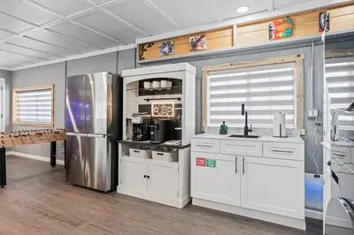a kitchen with white cabinets and a stainless steel refrigerator at 4000 SF, 20 Acre Gated Luxe Estate, Game Room, Pano View, Pool, Spa in Coarsegold