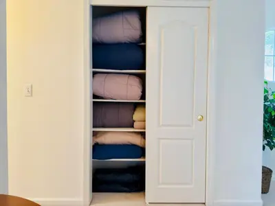 a closet with a door full of towels at Heaven Heights - HotTub, Pet Friendly, EV Outlet, Pool Table, Game Room, BBQ, FirePit, Library in Oakhurst
