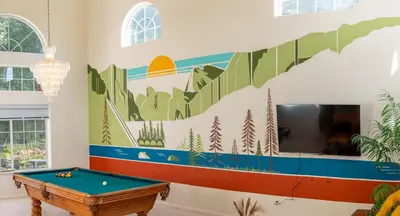 a living room with a pool table and a mural on the wall at Heaven Heights - HotTub, Pet Friendly, EV Outlet, Pool Table, Game Room, BBQ, FirePit, Library in Oakhurst