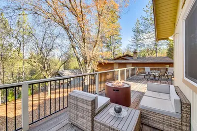 a deck with a couch and chairs on a balcony at Deck and Fire Pit Pine Mountain Lake Getaway! in Groveland