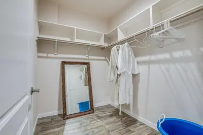 a dressing room with a mirror on the wall and a blue chair at On-Site Winery Rural Plymouth Getaway! in Plymouth