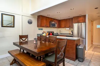 a kitchen with a wooden table with chairs and a counter at Well Kept Condo CS#3 - Pets OK in Bear Valley