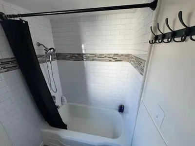 a bathroom with a bath tub and a shower at Midtown Hideaway 1 BR Nest in Reno