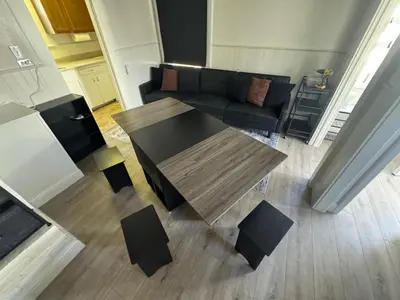 a living room with a table and a couch at Midtown Hideaway 1 BR Nest in Reno