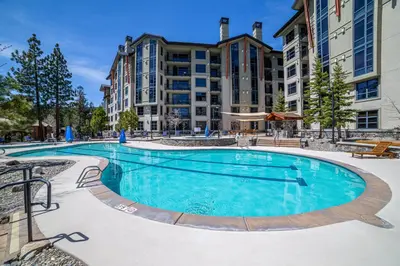 a swimming pool at a hotel with buildings in the background at Updated Pet Friendly Monache Studio with Views! in Mammoth Lakes