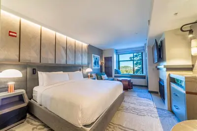 a hotel room with a large bed and a kitchen at Updated Pet Friendly Monache Studio with Views! in Mammoth Lakes