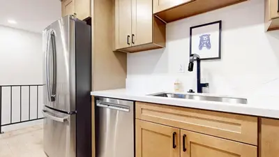 a kitchen with wooden cabinets and a stainless steel refrigerator at Lakeview Villas #06 condo in Mammoth Lakes