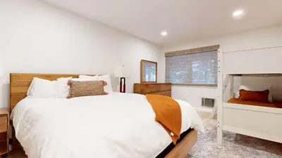 a white bedroom with a large bed and a window at Lakeview Villas #06 condo in Mammoth Lakes