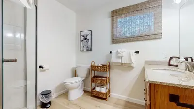 a white bathroom with a toilet and a sink at Lakeview Villas #06 condo in Mammoth Lakes