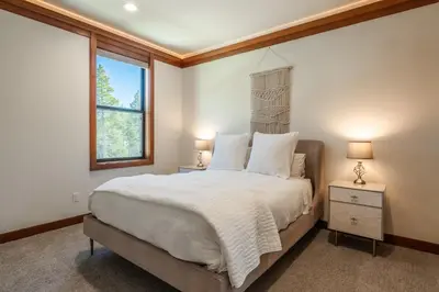 a bedroom with a large bed and a window at Obsidian 210 in Mammoth Lakes