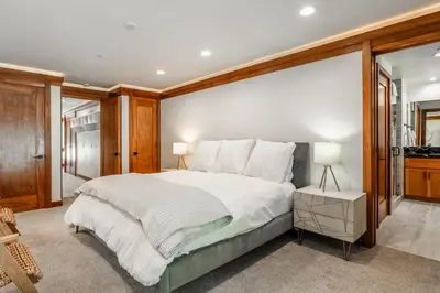 a bedroom with a large bed with wooden walls at Obsidian 210 in Mammoth Lakes