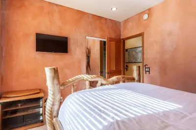 a bedroom with a bed and a tv on the wall at XXL Snowcreek #747 - 5 Bedroom 4 Bathroom Sleeps 12 Pet Friendly, Amazing Mountain Views in Mammoth Lakes
