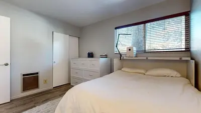 a bedroom with a large bed and a window at Sierra Manors #61 condo in Mammoth Lakes